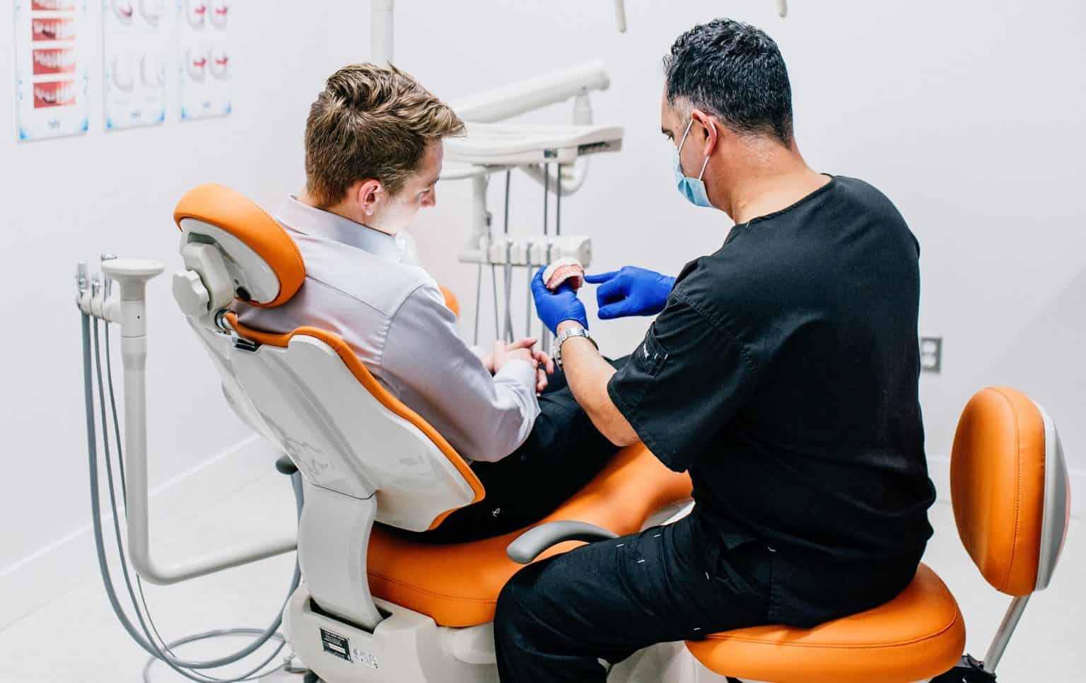 Denturist explaining how dentures work to a new patient