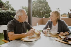 Senior couple having breakfast outside